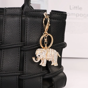 Sparkling elephant keychain with crystals on black bag, gold-plated animal bag charm