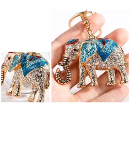 Detailed close-up of a sparkling gold-toned elephant keychain with blue rhinestones and enamel