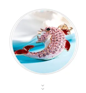Macro detail of crown dolphin pendant with pink zircon pave and white enamel belly