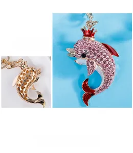 Detail of pink crystal dolphin keychain with gold heart-hollowed metal back and hook