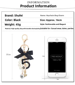 Detail view of black ribbon bow keychain with pearl beads and number 5 charm ornament