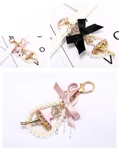 Détail du porte-clés ballerine avec nœud en soie, cristaux et perles blanches