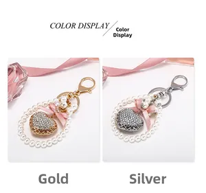 Detail view of heart-shaped pearl keychains with rhinestones and pink satin bows