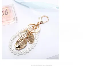 Detailed close-up of golden strawberry pendants with pearls and elegant silk ribbons