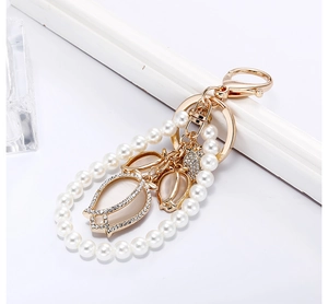 Close-up of tulip pearl keychain with cat-eye stone petals and sparkling rhinestones