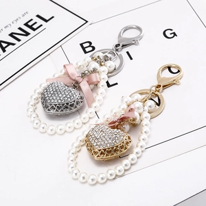 Sparkling heart keychain with rhinestones, pearls and a pink bow for women bag charm