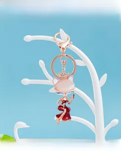 Detail of fox pendant with pink gemstone and red enamel dress on rose gold frame
