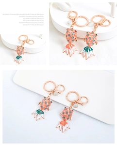 Macro detail of goldfish keychain with rose gold finish, colorful gems and enamel tail