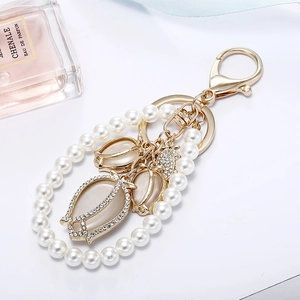 Elegant pearl keychain with opal tulip charms and crystal accents on gold lobster clasp
