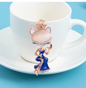 Close-up of elegant fox pendant with pink opal head and blue enamel floral gown
