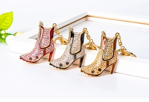 Detail view of sparkly rhinestone high heel boot keychains in various stylish colors
