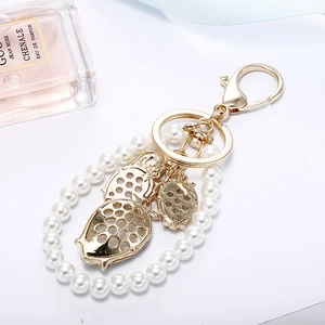 Elegant gold strawberry pendant keychain with white pearls and durable lobster clasp