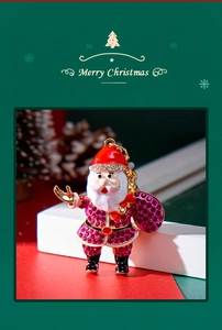 Detailed view of Santa Claus keychain with sparkling red and purple rhinestones
