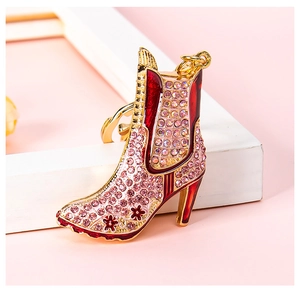 Macro shot of high heel boot keychain with pink rhinestones and gold alloy details