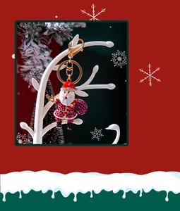 Detailed view of Santa Claus keychain with red rhinestones and golden lobster clasp