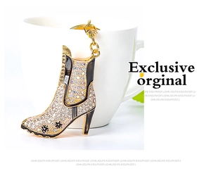 Detailed close-up of crystal-encrusted high heel boot keychain with black enamel floral accents