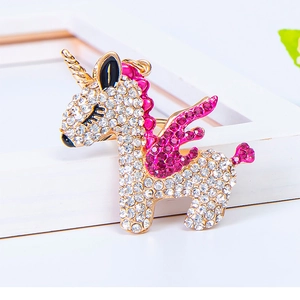 Close-up of crystal-encrusted unicorn keychain with pink wings and gold-plated alloy finish