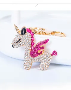 Close-up of sparkling rhinestone unicorn keychain with gold metal plating for handbag