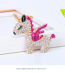 Detailed macro of crystal unicorn keychain with white and rose pink rhinestones