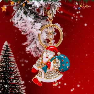 Portachiavi Babbo Natale scintillante con cristalli e smalto su uno sfondo rosso festivo
