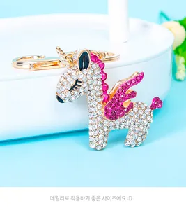 Close-up of gold-plated unicorn keychain with sparkling pink and white rhinestones