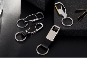 Detailed view of assorted metal and leather keychains in a luxury gift box