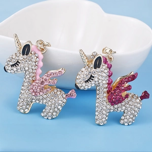 Sparkly rhinestone flying unicorn keychain pendants in pink and purple with gold finish
