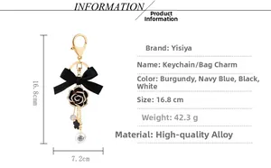 Detailed view of camellia keychain with pearl, ribbon bow and product dimensions
