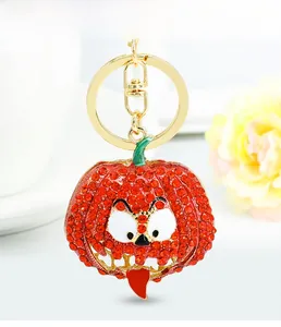 Macro shot of Halloween pumpkin keychain with sparkling rhinestones and golden clip