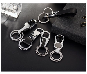 Detail shot of premium business metal and black leather keychains in various designs
