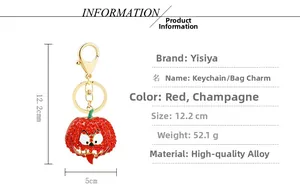 Detail view of pumpkin smile keychain showing dimensions of 12.2cm and rhinestone inlay