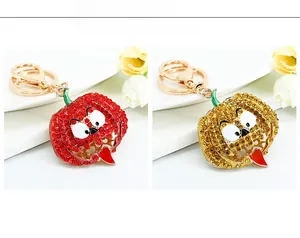 Detail view of pumpkin keychains with sparkling red and gold rhinestones and funny faces