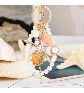 Macro detail of starfish and shell pendant with colorful rhinestones and white pearls