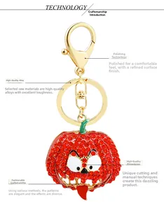 Detailed view of pumpkin keychain with polished gold alloy and sparkling red rhinestones