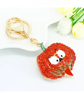 Detail of creative Halloween pumpkin keychain with sparkling red rhinestones and gold ring