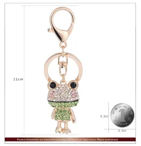 Detailed macro view showing a 11cm sparkly rhinestone frog keychain with gold alloy finish