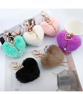Detailed close-up of colorful heart plush keychains with pearls and gold alloy clasps