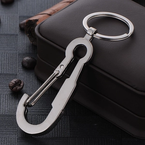 Polished silver metal car keychain with snap hook design on brown leather background