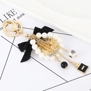 Elegant bow and pearl keychain with black camellia flower and perfume bottle charms
