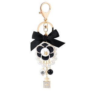 Elegant camellia bow keychain with pearls and rhinestone perfume bottle pendant