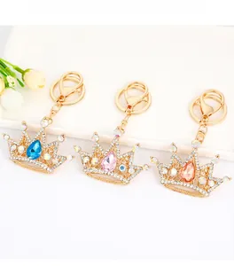 Close-up of crown keychains with blue, pink, and champagne pear-shaped crystals