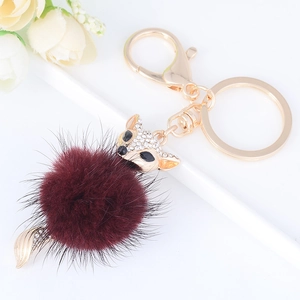 Plush burgundy fox keychain with golden crystal head and fluffy faux fur ball pendant