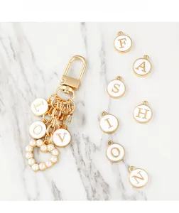 Detailed macro view of gold-plated LOVE alphabet charms with pearl heart pendant