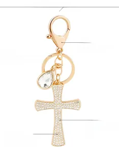 Detailed close-up of sparkling rhinestone cross keychain with gold-plated spring clasp