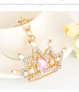 Detailed macro view of the gold crown keychain with sparkling pink pear-shaped crystal