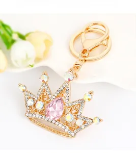 Detail of a crystal crown keychain with pink gemstone and sparkling rhinestones