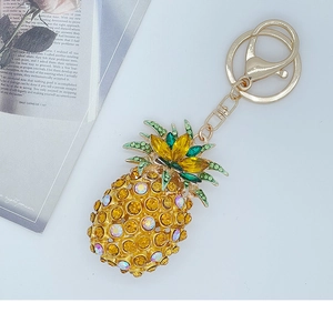 Detail of pineapple keychain featuring yellow and green rhinestones on gold alloy base
