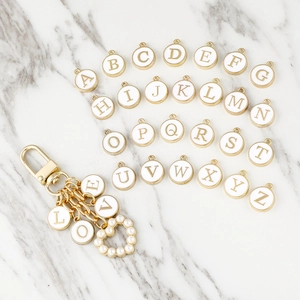 DIY Alphabet Keychain with Gold Letter Charms and Pearl Heart Pendant on Marble