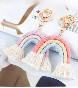 Macro detail of handmade rainbow keychain with colorful cotton rope and soft white tassels