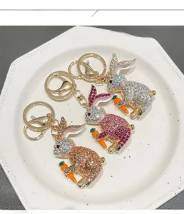 Detailed close-up of rabbit keychains with rhinestones in pink, silver, and champagne gold